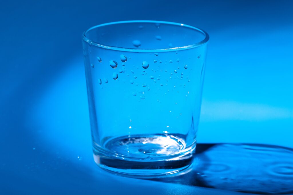 a glass with water drops on a dark blue background 2023 11 27 05 33 19 utc 1