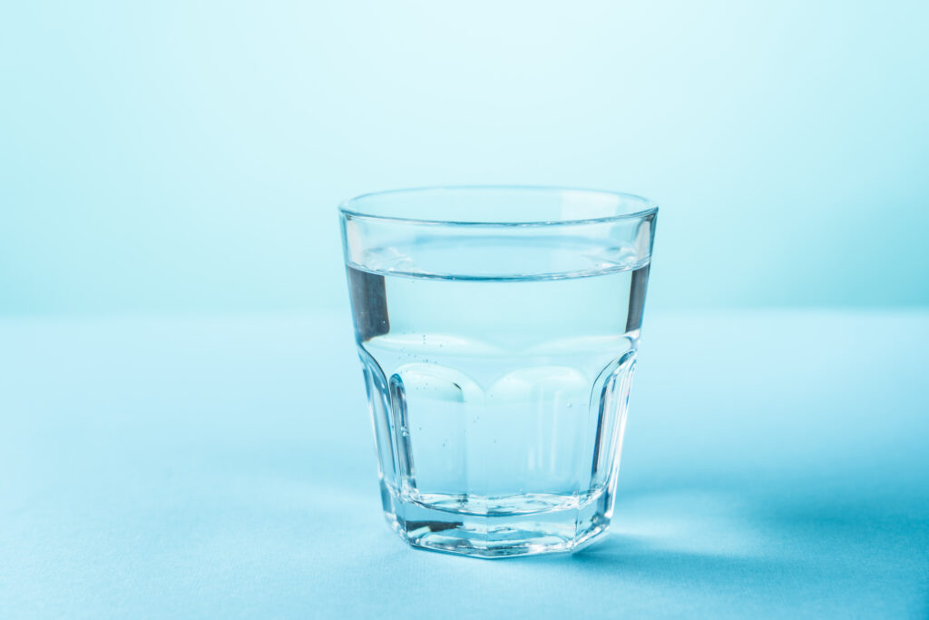glass of water on blue background 2025 02 15 05 39 46 utc